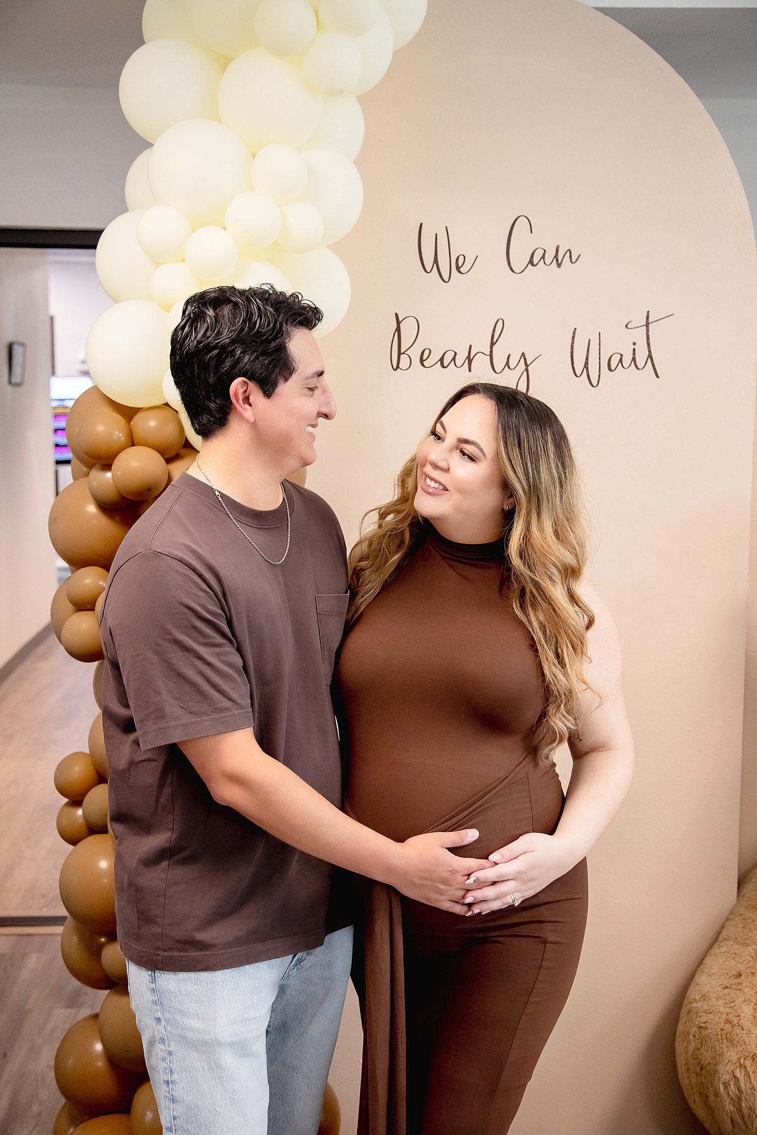 husband and wife cradle her baby bump at a shower by Southern California wedding photographer