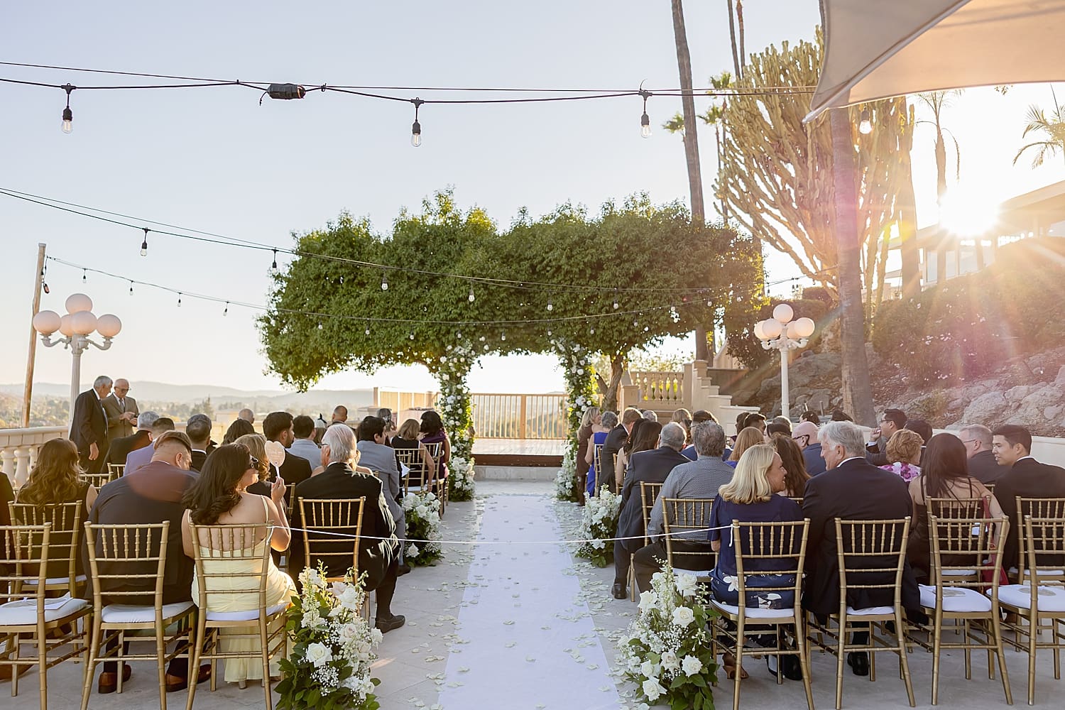 elegant outdoor ceremony set up at golden hour by Southern California wedding photographer