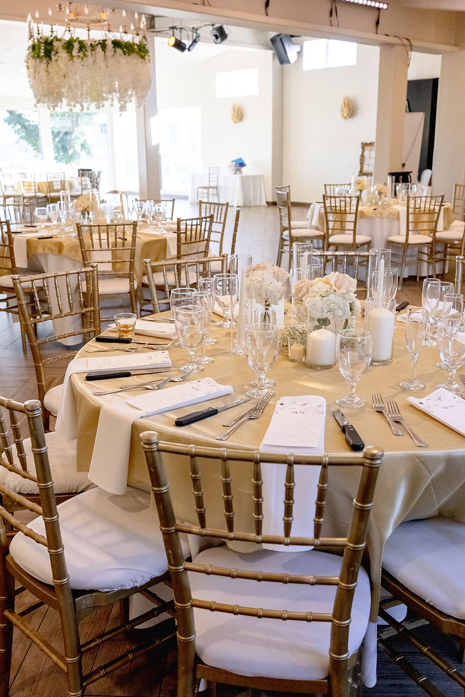 elegant reception set up in ballroom with big windows by Southern California wedding photographer