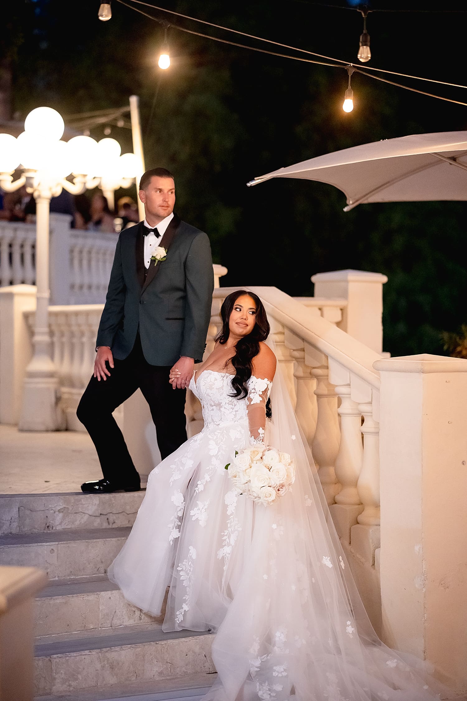newly married couple stand on elegant steps by Desiree Ashley Photography