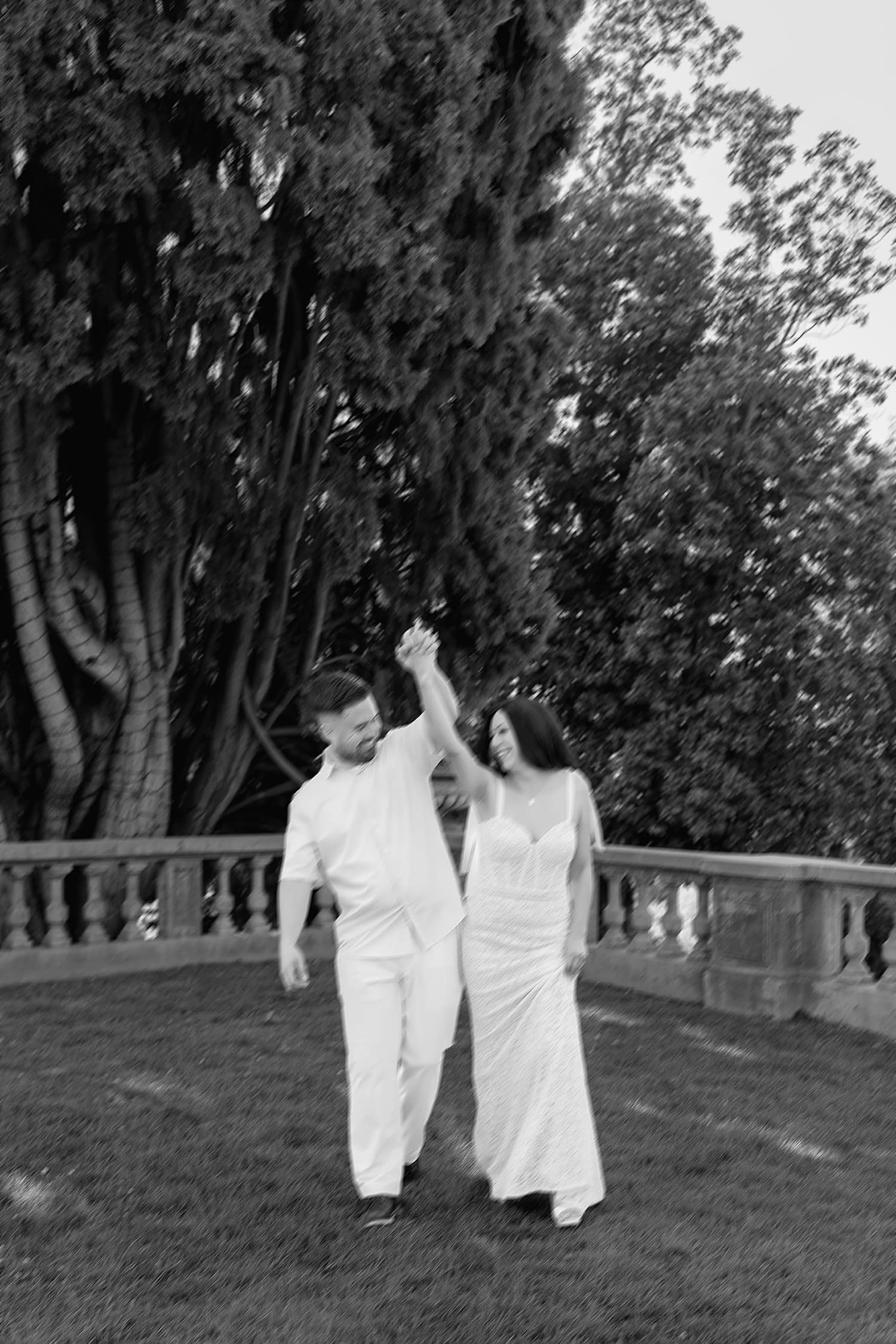 couple walk playfully in the garden at Kimberly Crest House & Gardens