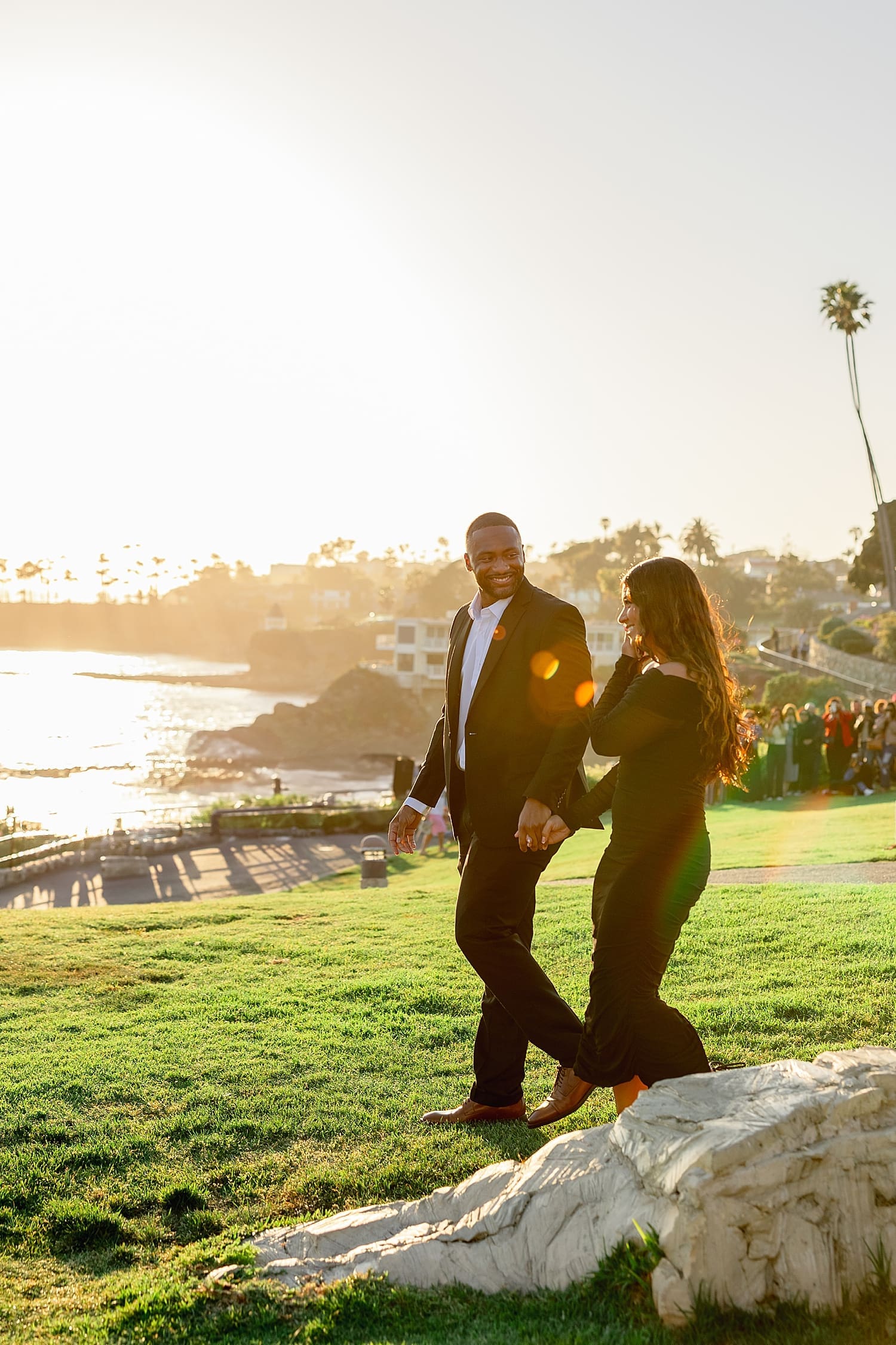 couple walks across overlook at sunset by Desiree Ashley Photography