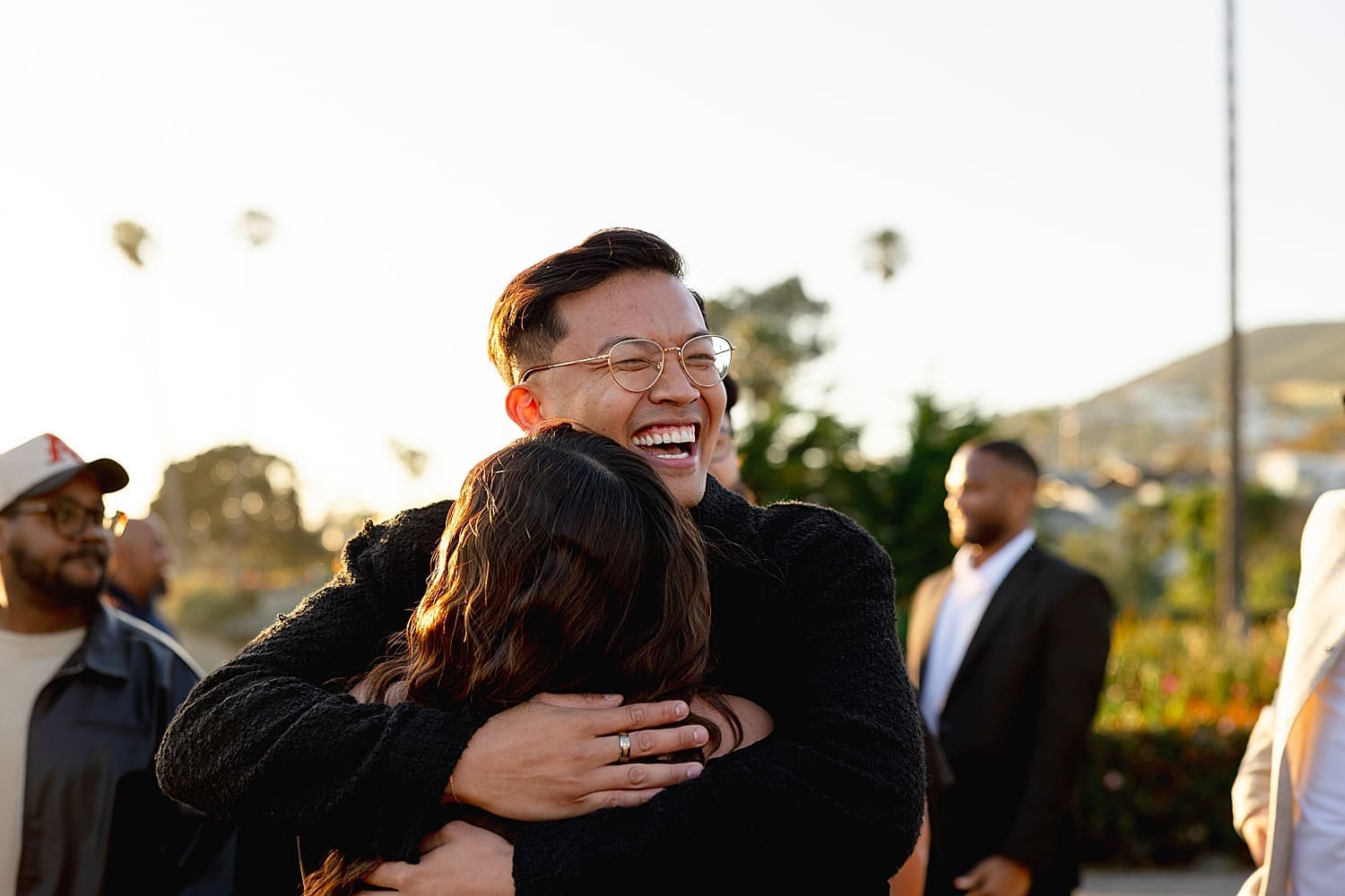 friend hugs his newly engaged friend by Southern California wedding photographer