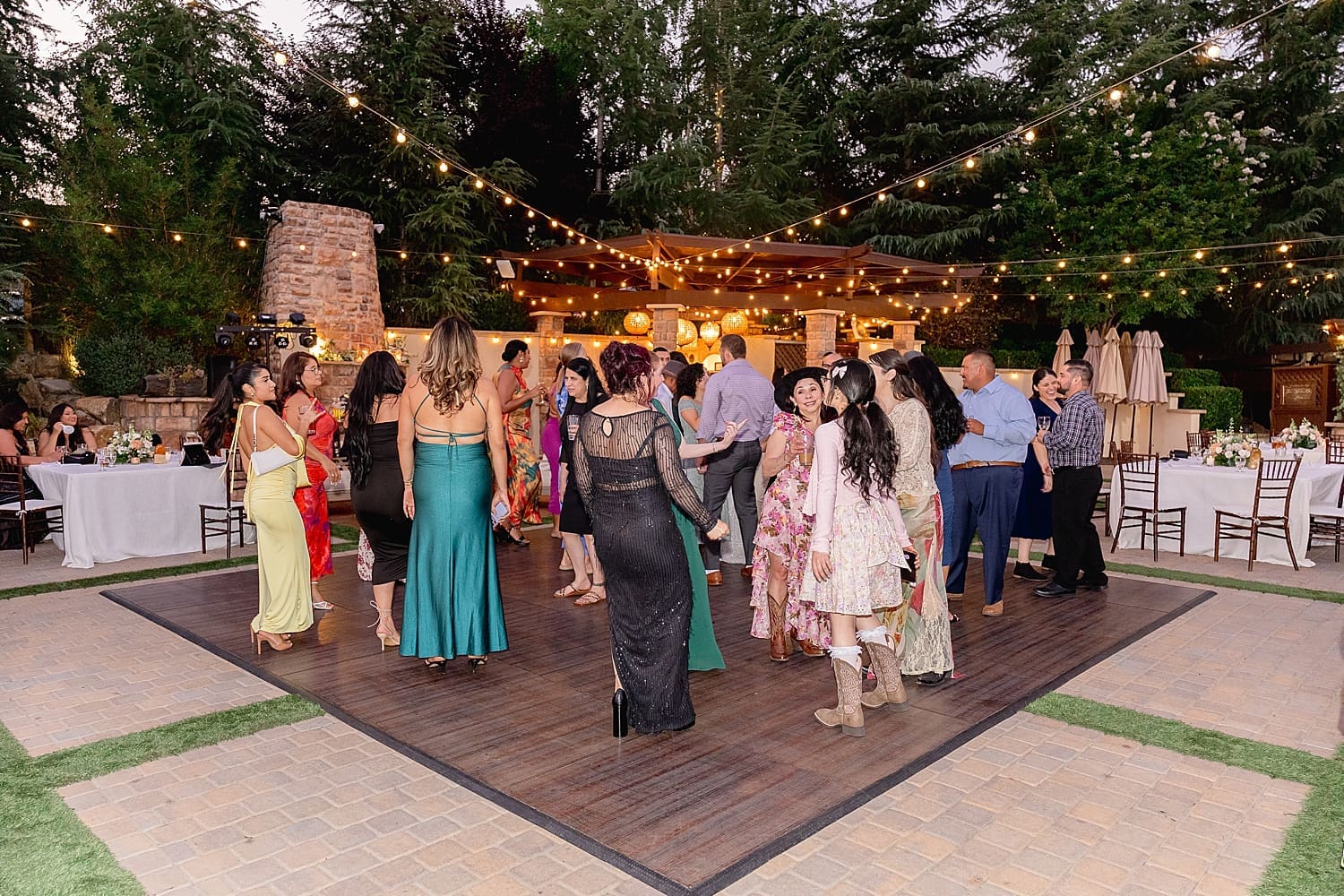 guests dance in fading light under twinkle lights by Desiree Ashley Photography