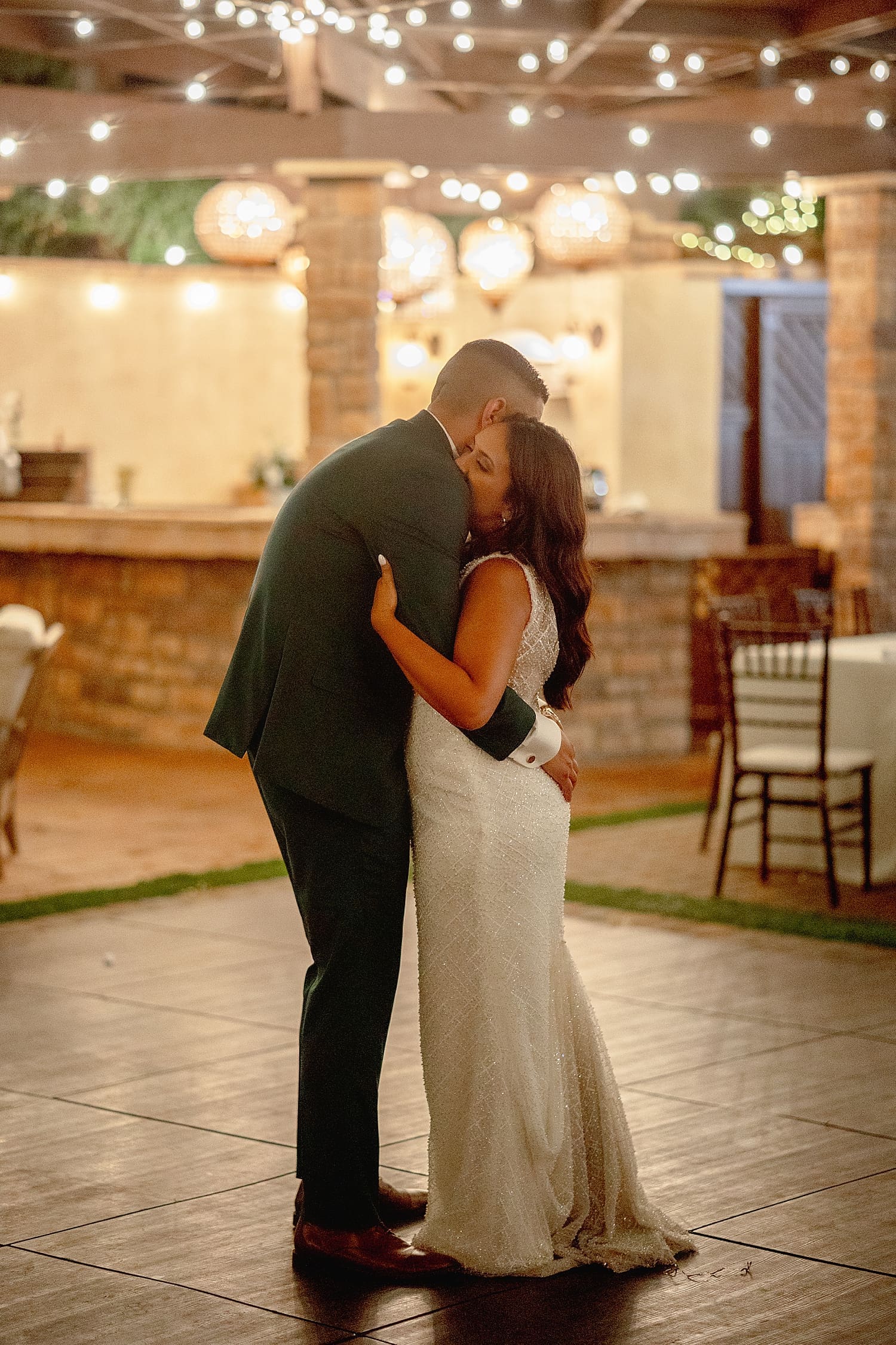 newlyweds share a last dance under twinkle lights at Serendipity Gardens