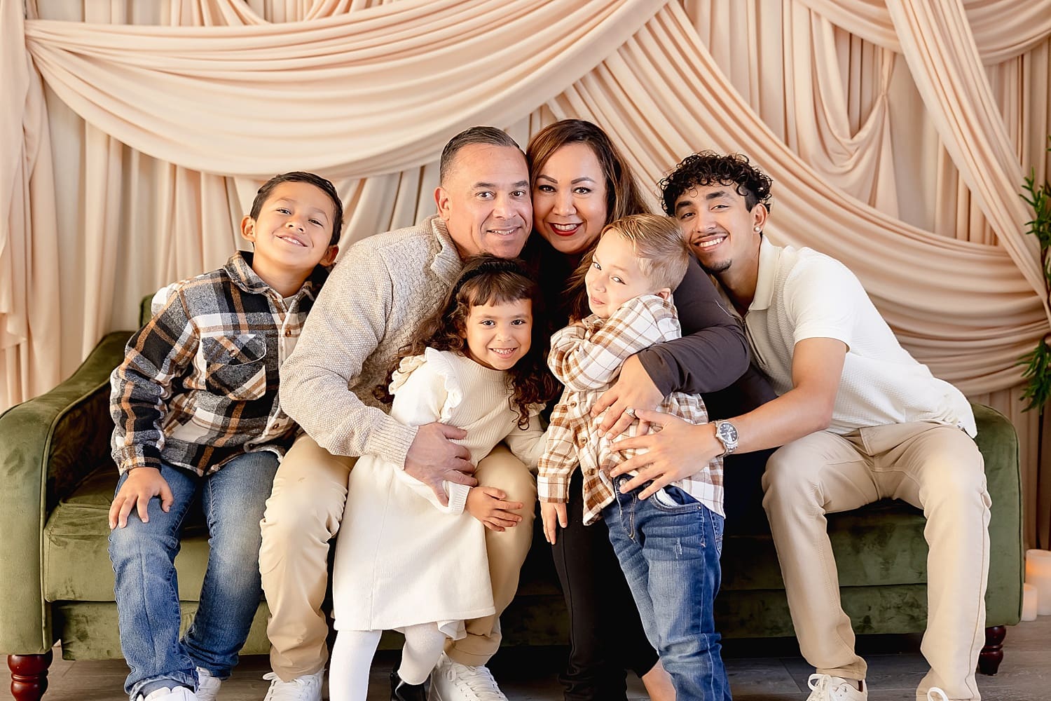 parents sit with their kids in draped studio by Southern California photographer