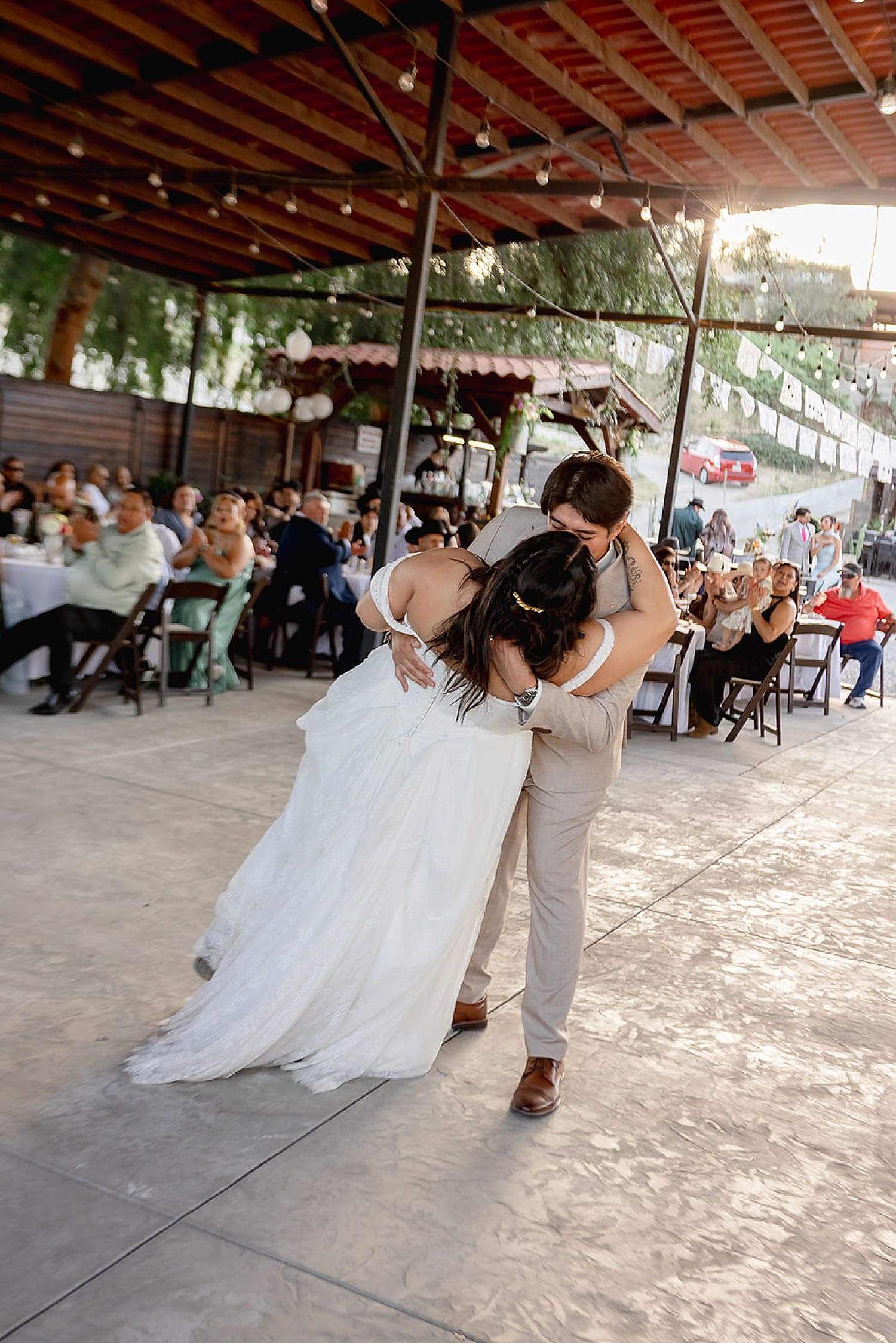 groom dips bride for kiss during reception by Desiree Ashley Photography