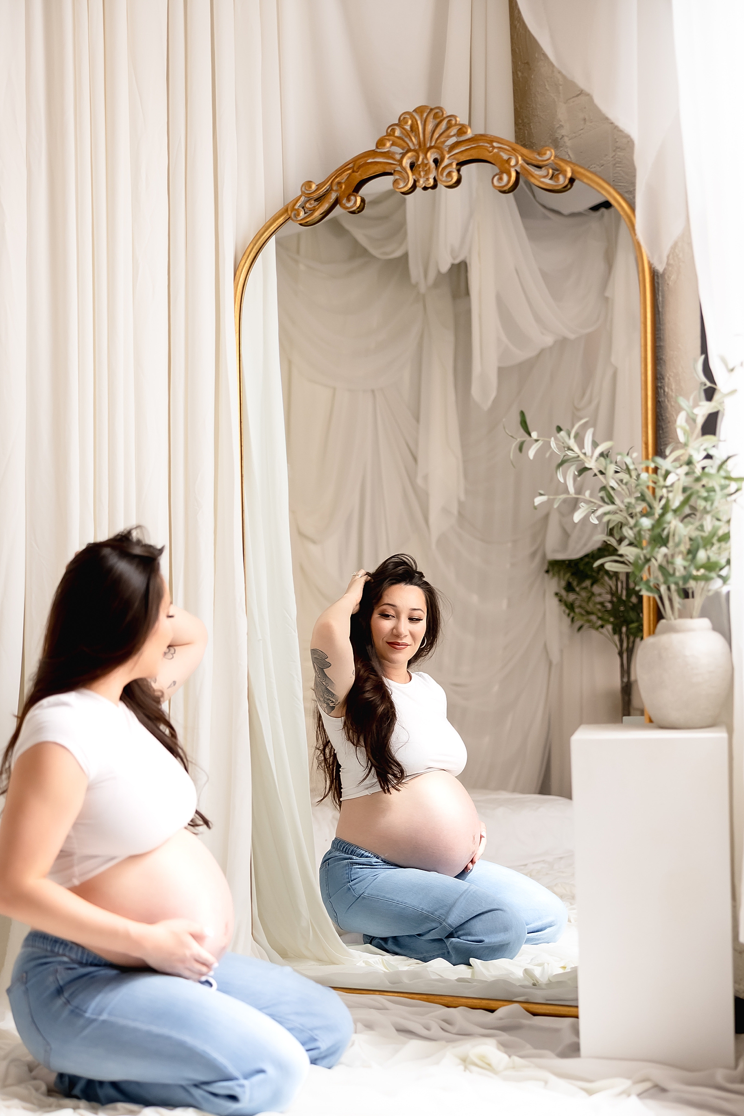 brunette mom kneels in front of gold mirror by Desiree Ashley Photography