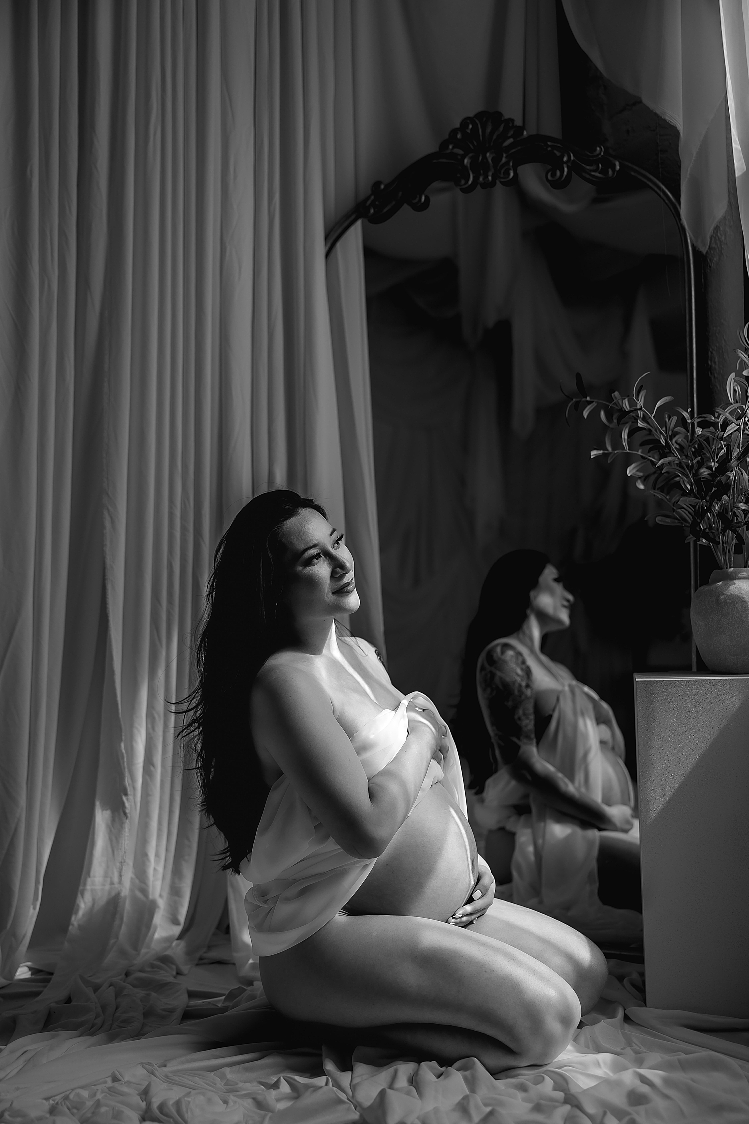 pregnant mom sits on floor in front of mirror by Southern California photographer