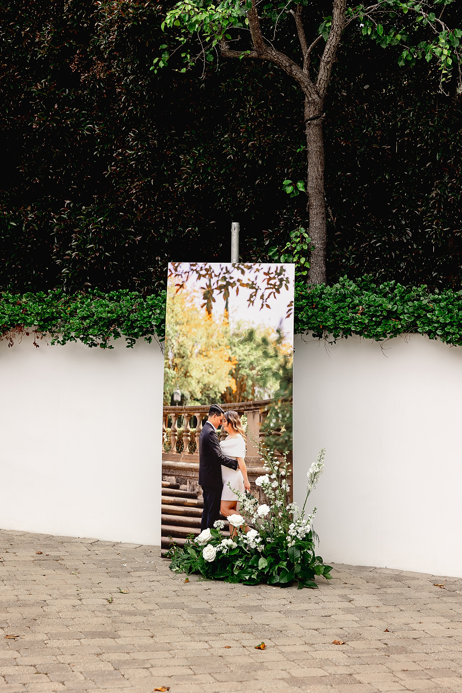 tall poster of couple embracing in courtyard by Desiree Ashley Photography